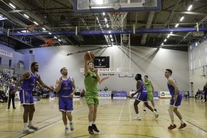 James Fernane gets to the board as the Demons defence watches on