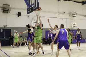 Padraig Fleming and Dorian Lagoeyte battle for the ball under the Saints board