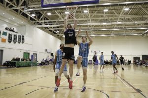 Cian Sullivan slams in a dunk as Greg Adon and Eoin Nelson look on