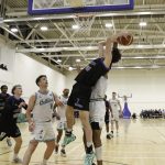 Dan Bowler at full stretch to gather the ball under the Celtics basket