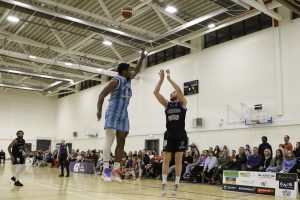 Daniel Jokubaitis fires in a three pointer despite the attentions of Michael Hayes