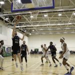 Eoin Quigley finishes as Abdul Wurie looks on