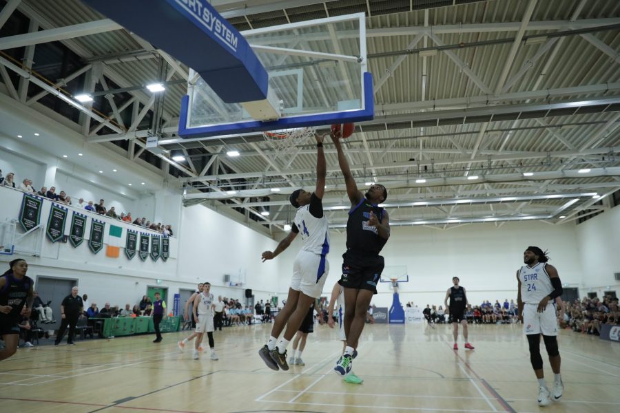Alec Millender tips in over Shane Bell